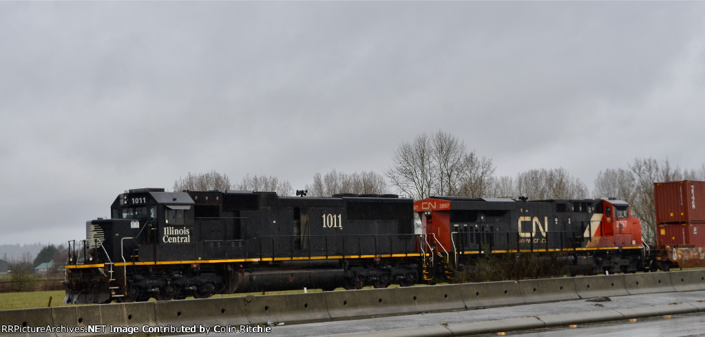 waiting for a fresh crew in Fisher Siding, IC 1011 leading CN 2897, a unit stack train headed E/B to Chicago from Delta, B.C.